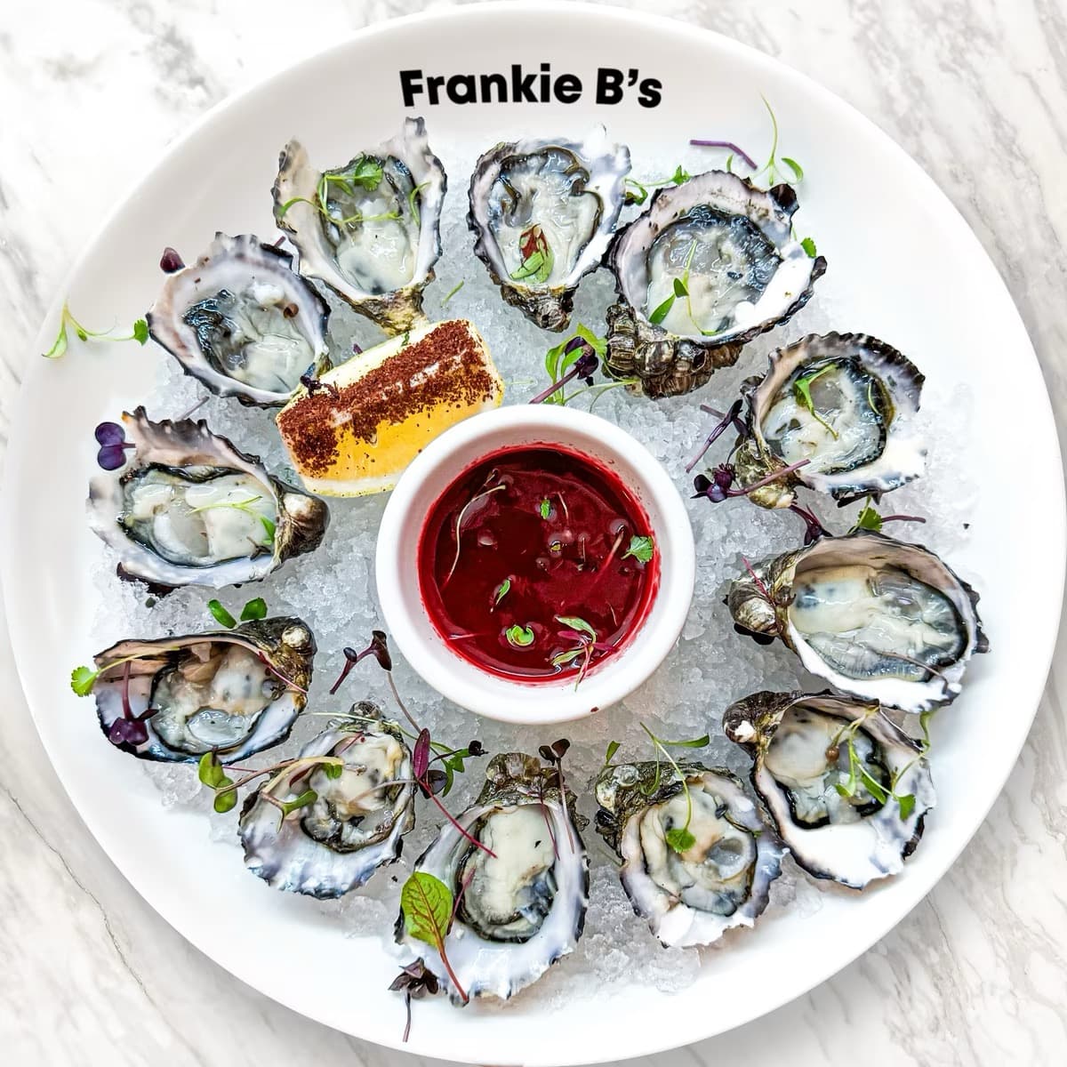 Pacific Oysters at Frankie B's Food House – Fresh oysters served with sumac lemon, available in natural, Kilpatrick, or Mornay