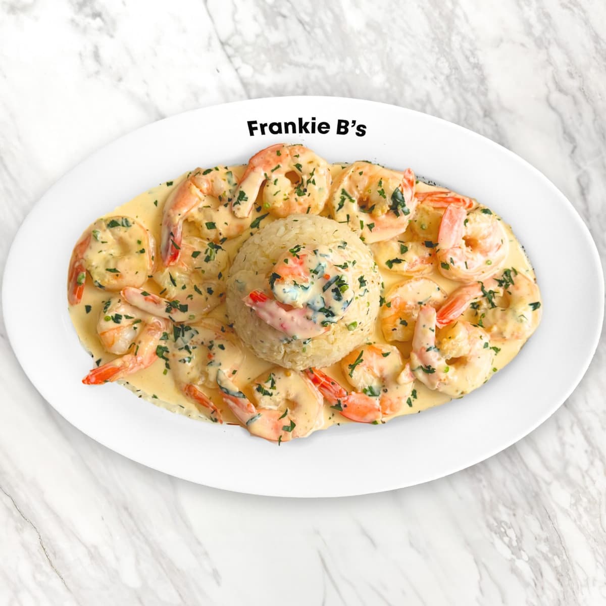 Frankie B’s garlic cream prawns served with rice on a white plate